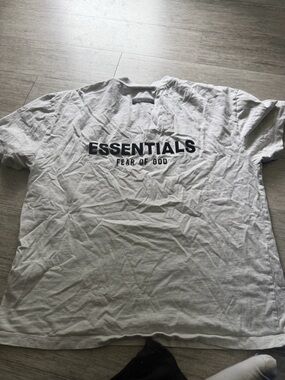 Fear of God Essentials T-shirt, likely in a Light Heather Gray